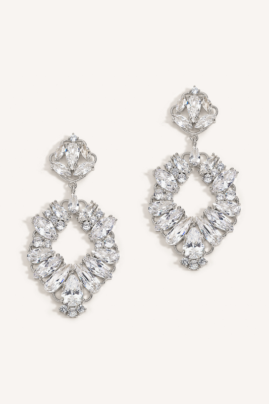 A pair of drop earrings featuring multiple round crystals set in a metallic frame, presented against a white background.